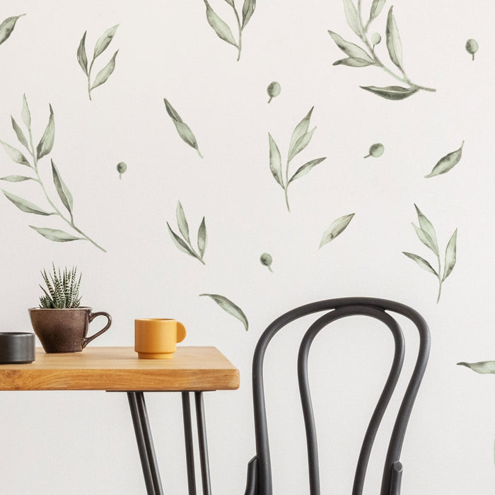 Olive leaf wall stickers on a white dining room wall. Plastic-free wall decals.